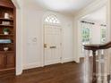 Elegant entryway with hardwood floors and arched doorway and trim at 208 Huntley Pl, Charlotte, NC 28207