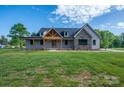 A view of the home's exterior featuring a welcoming front porch and well-manicured front lawn at 2313 Ivey Church Rd, Maiden, NC 28650