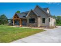 Charming single-Gathering home with beautiful stone accents and covered front porch, set on a lush green lawn at 2313 Ivey Church Rd, Maiden, NC 28650