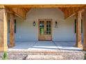 Inviting front porch featuring wooden posts and double glass doors at 2313 Ivey Church Rd, Maiden, NC 28650