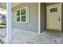 Covered porch featuring gray siding and a door at 2706 Lyla Ave, Concord, NC 28027