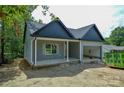 View of the home showing gray siding and a two car garage at 2706 Lyla Ave, Concord, NC 28027