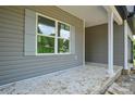 Covered porch featuring gray siding, a window, and a support column at 2706 Lyla Ave, Concord, NC 28027