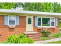 Close up of the home's brick facade, light shutters, and well-kept front garden at 2833 Regency Rd, Lancaster, SC 29720