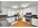 Bright kitchen with stainless appliances, granite countertops, and white cabinetry at 2833 Regency Rd, Lancaster, SC 29720