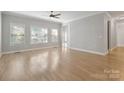 Bright open-concept living room with hardwood floors and multiple windows, ceiling fan at 2923 Meadow Creek Ln, Monroe, NC 28110