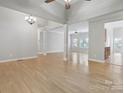 Spacious living room with hardwood floors and natural light, adjacent to kitchen at 2923 Meadow Creek Ln, Monroe, NC 28110
