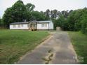 Exterior shot of a single-story home featuring a long driveway and outbuilding at 3315 Buffalo Shoals Rd, Newton, NC 28658