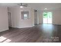 Open-concept living room featuring modern flooring and natural light from sliding glass doors at 3315 Buffalo Shoals Rd, Newton, NC 28658
