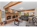 Cozy living room with a large brick fireplace, exposed beams, and a comfortable leather sofa at 341 N Mulberry St, Statesville, NC 28677