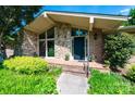 Inviting home entrance with brickwork, stone accents, and black front door at 3520 4Th Street Nw Blvd, Hickory, NC 28601