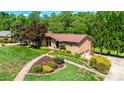Well maintained lawn, mature trees and landscaping surround this brick home at 3520 4Th Street Nw Blvd, Hickory, NC 28601