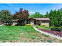Charming brick home with stone accents, lush lawn, and mature landscaping at 3520 4Th Street Nw Blvd, Hickory, NC 28601