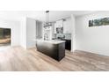 Beautiful kitchen island with a sink, modern appliances and hardwood floors at 413 Jose St, Shelby, NC 28150