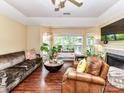 Cozy living room featuring hardwood floors, a fireplace, and large windows at 517 N Graham St # 3E, Charlotte, NC 28202
