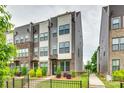 Modern townhome showcasing a brick and siding exterior with a small fenced front yard at 556 Billingsley Rd, Charlotte, NC 28211