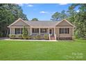 Single-story home featuring a well-manicured lawn and inviting front porch at 5564 N Hillsdale Dr, Fort Lawn, SC 29714