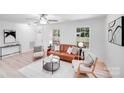 Bright living room featuring a stylish leather sofa, modern decor, and ample natural light at 5564 N Hillsdale Dr, Fort Lawn, SC 29714