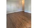 Spacious room with light gray walls, white trim and gorgeous wood grain laminate flooring throughout at 623 S New Hope Rd # 9, Gastonia, NC 28054