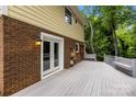 Spacious back deck with white railings and brick wall, perfect for outdoor entertaining at 6713 William Harry Ct, Charlotte, NC 28211