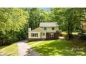 Charming two-story home features a brick foundation, inviting entrance, and lush, mature landscaping at 6713 William Harry Ct, Charlotte, NC 28211