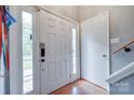 Bright home entryway featuring a secure digital lock, hardwood floors and access to the staircase at 679 Fairforest Rd, Chester, SC 29706