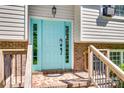 Close-up of a home's attractive blue front door flanked by sidelights and a brick facade at 679 Fairforest Rd, Chester, SC 29706