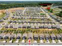 Aerial view of a neighborhood featuring many homes and the community pool and tennis courts at 9037 Remnick Dr, Gastonia, NC 28056