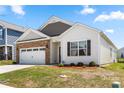 Well-maintained single-Gathering home with a two-car garage, brick accents, and a manicured lawn at 9037 Remnick Dr, Gastonia, NC 28056