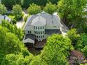 A beautiful backyard view of the home featuring a patio, deck and pristine landscaping at 9311 St Barts Ln, Huntersville, NC 28078