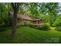 A home with a spacious wooden deck surrounded by lush greenery at 104 Ridge Dr, Stanley, NC 28164
