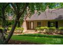 A charming brick home with a welcoming front porch and beautiful landscaping at 104 Ridge Dr, Stanley, NC 28164