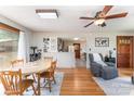 Open-concept dining area with hardwood floors, a wooden table, and easy access to the kitchen and living spaces at 1102 E 13Th St, Kannapolis, NC 28083