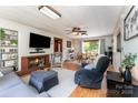 Inviting living room featuring a cozy fireplace, plush seating, and hardwood floors, creating a warm atmosphere at 1102 E 13Th St, Kannapolis, NC 28083
