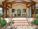 Inviting front porch with brick steps, detailed wood beams, and a cozy bench seating area at 1139 Yale Pl, Charlotte, NC 28209