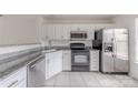 Kitchen featuring stainless appliances, granite counters, and white cabinetry at 12749 Mosby Ln, Charlotte, NC 28273