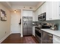 Well-equipped kitchen featuring stainless steel appliances, ample white cabinetry, and stylish backsplash at 1320 Fillmore Ave # 426, Charlotte, NC 28203