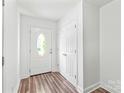 Bright foyer with wood floors and a white entry door leading to the exterior at 1707 Kashmir White Ln, Fort Mill, SC 29708