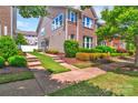 Charming two-story home featuring brick and vinyl siding with a lush lawn and driveway at 17913 Ragtop Day Ln, Cornelius, NC 28031