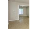 The neutrally decorated living room features an open transition to a neighboring room, enhanced by attractive tile flooring at 1905 Mereview Ct # 21, Charlotte, NC 28210