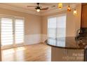Bright dining area with hardwood floors, pendant lighting, and access to outdoor space through glass doors at 2092 Ayrsley Town Blvd, Charlotte, NC 28273