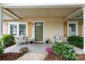 Inviting front porch with comfortable seating, decorative plants, and a welcoming entrance at 2212 Acme Rd, Belmont, NC 28012