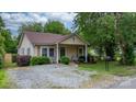 Inviting single story home featuring a cozy front porch, and well-maintained landscaping at 2212 Acme Rd, Belmont, NC 28012