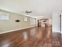 Spacious living room with hardwood floors, a ceiling fan, and access to the open kitchen at 2323 Arden St, Charlotte, NC 28206