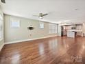 Spacious living room with hardwood floors, a ceiling fan, and access to the open kitchen at 2323 Arden St, Charlotte, NC 28206