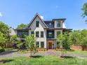 The black and white modern facade with green lawn is well-lit and inviting at 2608 Croydon Rd, Charlotte, NC 28209