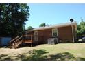 Exterior back of home featuring a wooden deck and well-maintained lawn at 288 S Sutton Rd, Fort Mill, SC 29708