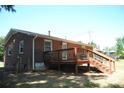 Back of brick home with a wooden deck and fenced area at 288 S Sutton Rd, Fort Mill, SC 29708