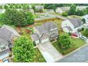 Aerial view of a home with a spacious backyard, a playset, and a three-car garage in a leafy neighborhood at 3029 Allendale Dr, Fort Mill, SC 29707