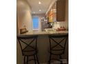 Kitchen with counter seating, granite countertops, stainless appliances, and tile flooring at 303 Heritage Pkwy, Fort Mill, SC 29715